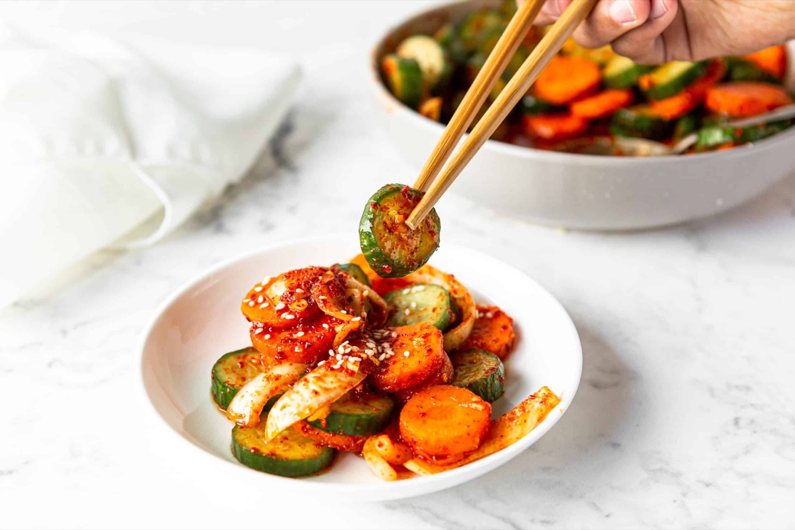 Cucumber kimchi picked up with chopsticks